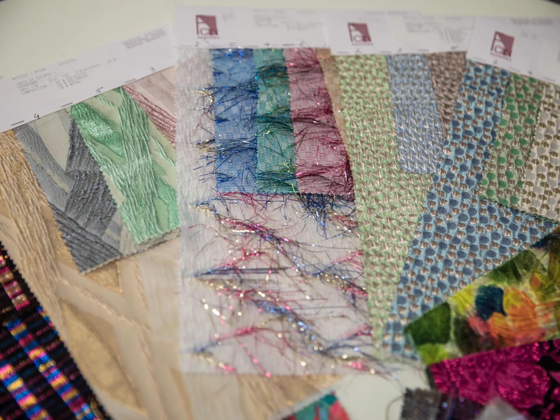 Colourful fabric swatches laid out for selection at CMT Studio London