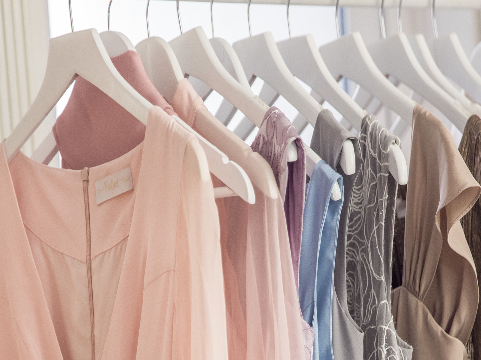 Pastel pink, lilac and blue garments hanging on a rail at CMT Studio London