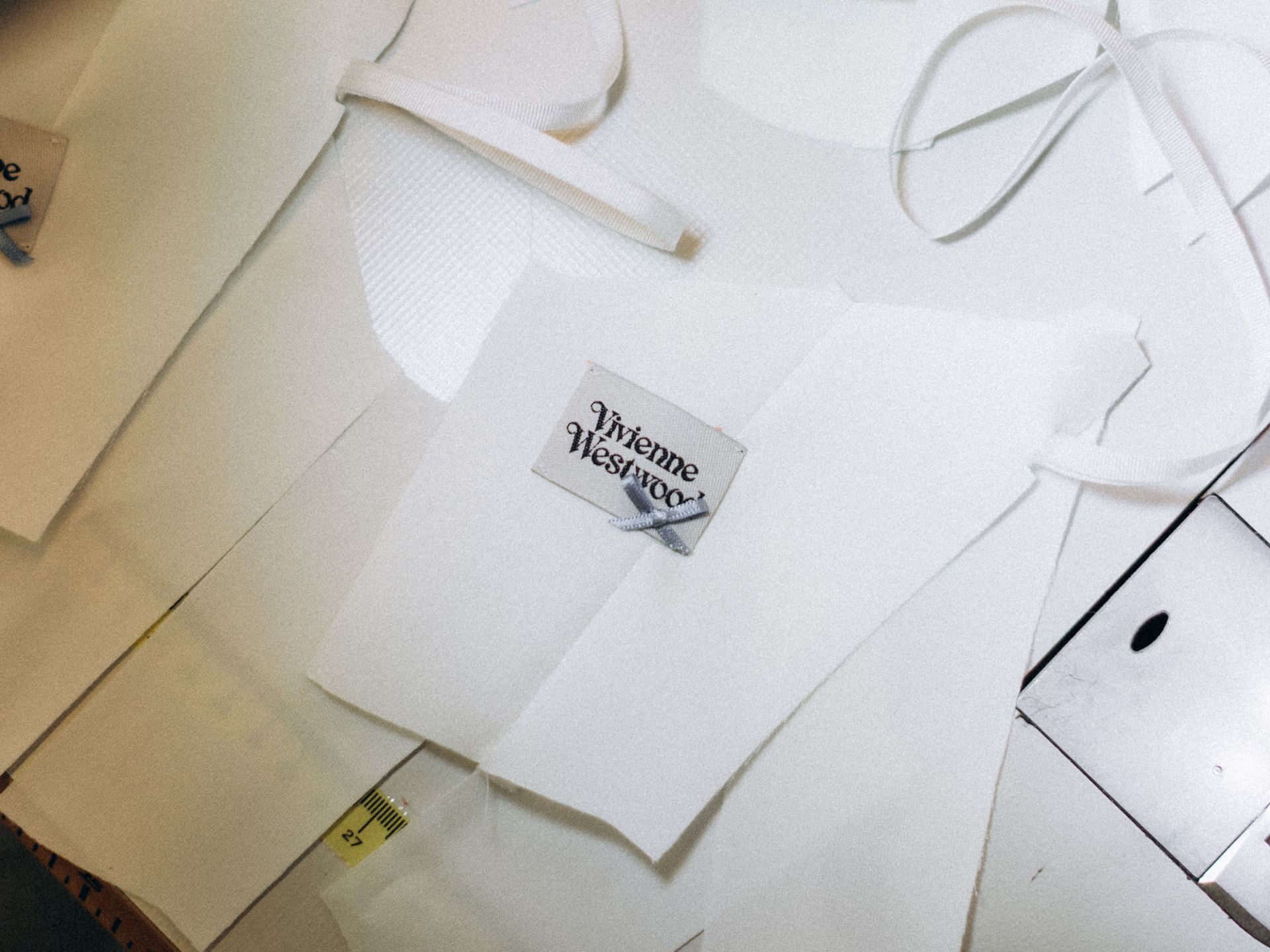 Pattern pieces and trims laid out on the cutting table in the London studio