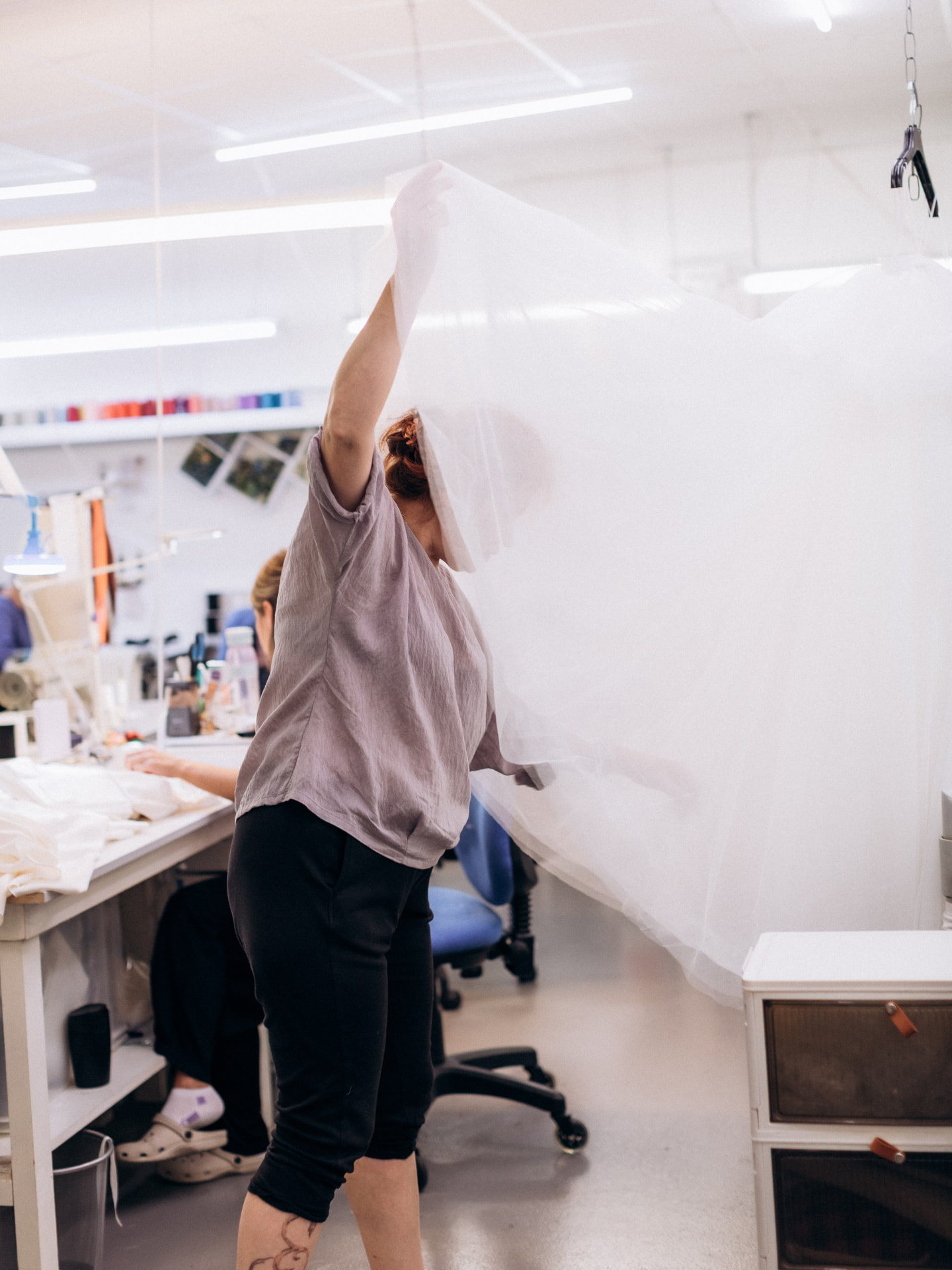 Studio team member handling bridal tulle in the CMT Studio workroom