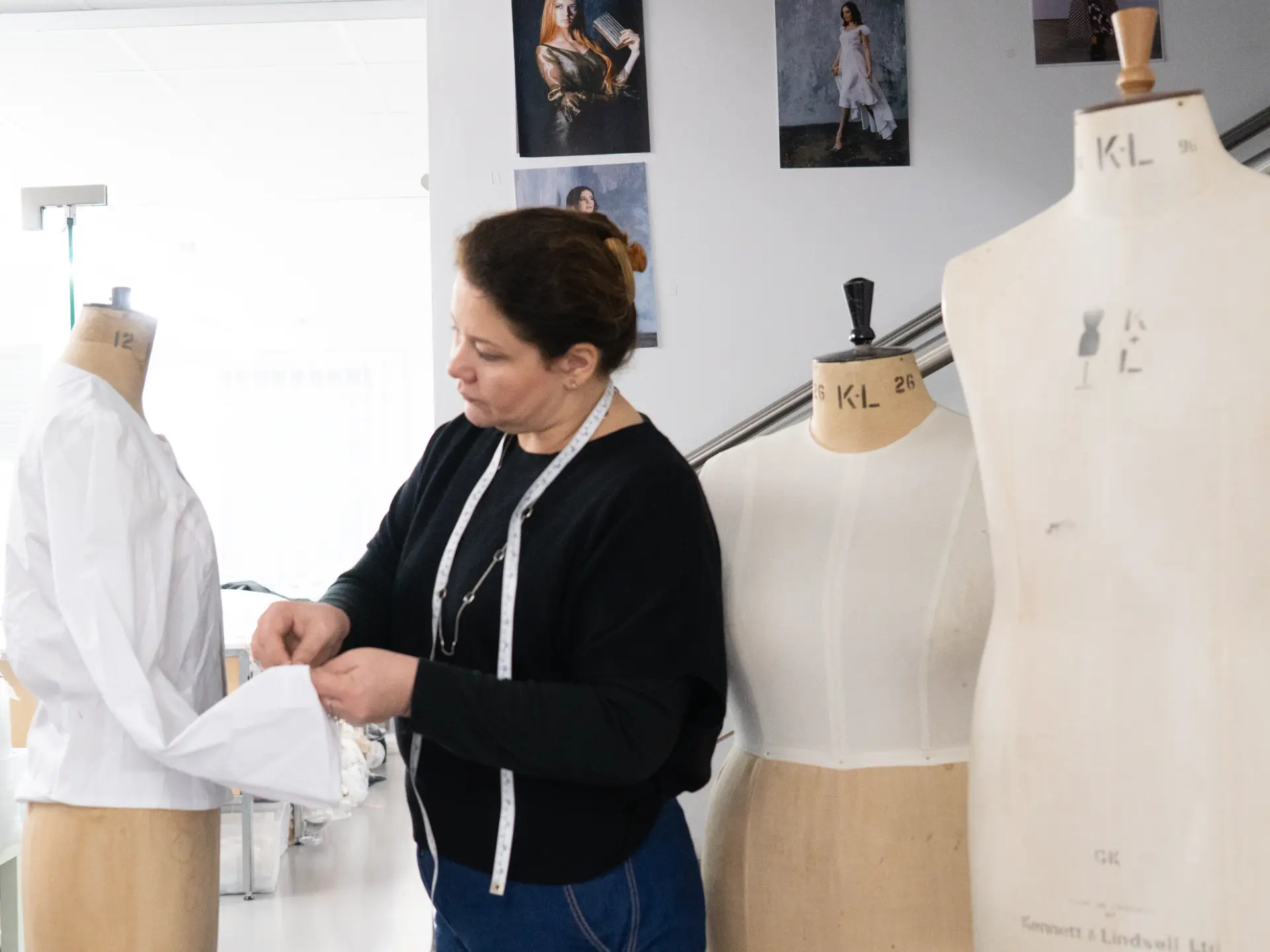 Woman adjusting a white garment on a dress form at CMT Studio London