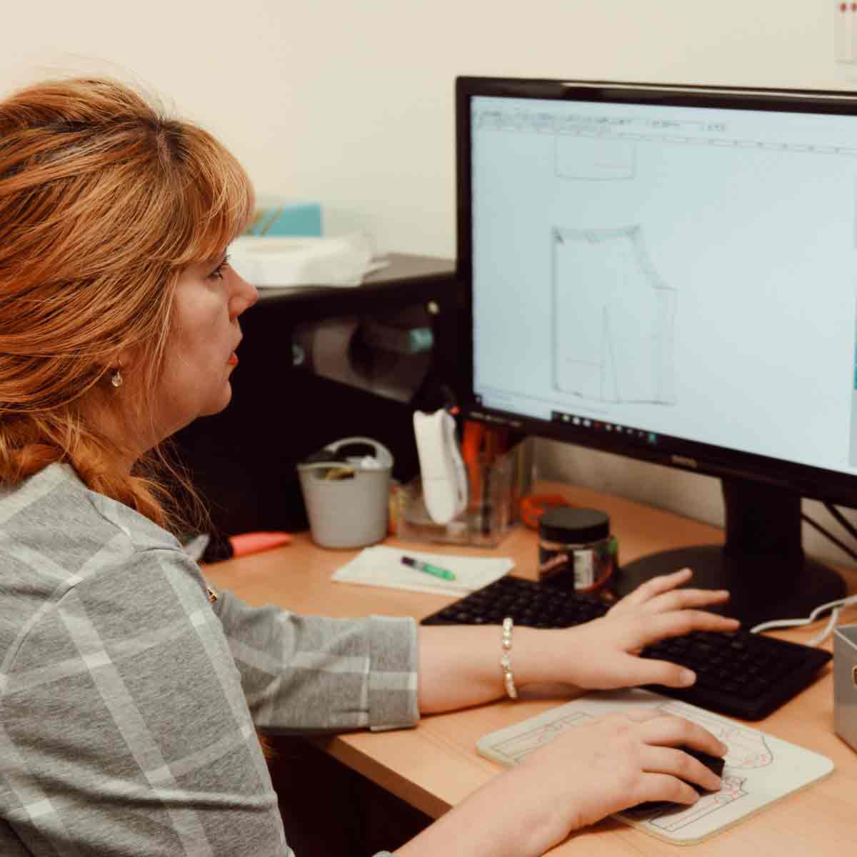 Woman reviewing a digital garment pattern on a computer at CMT Studio London