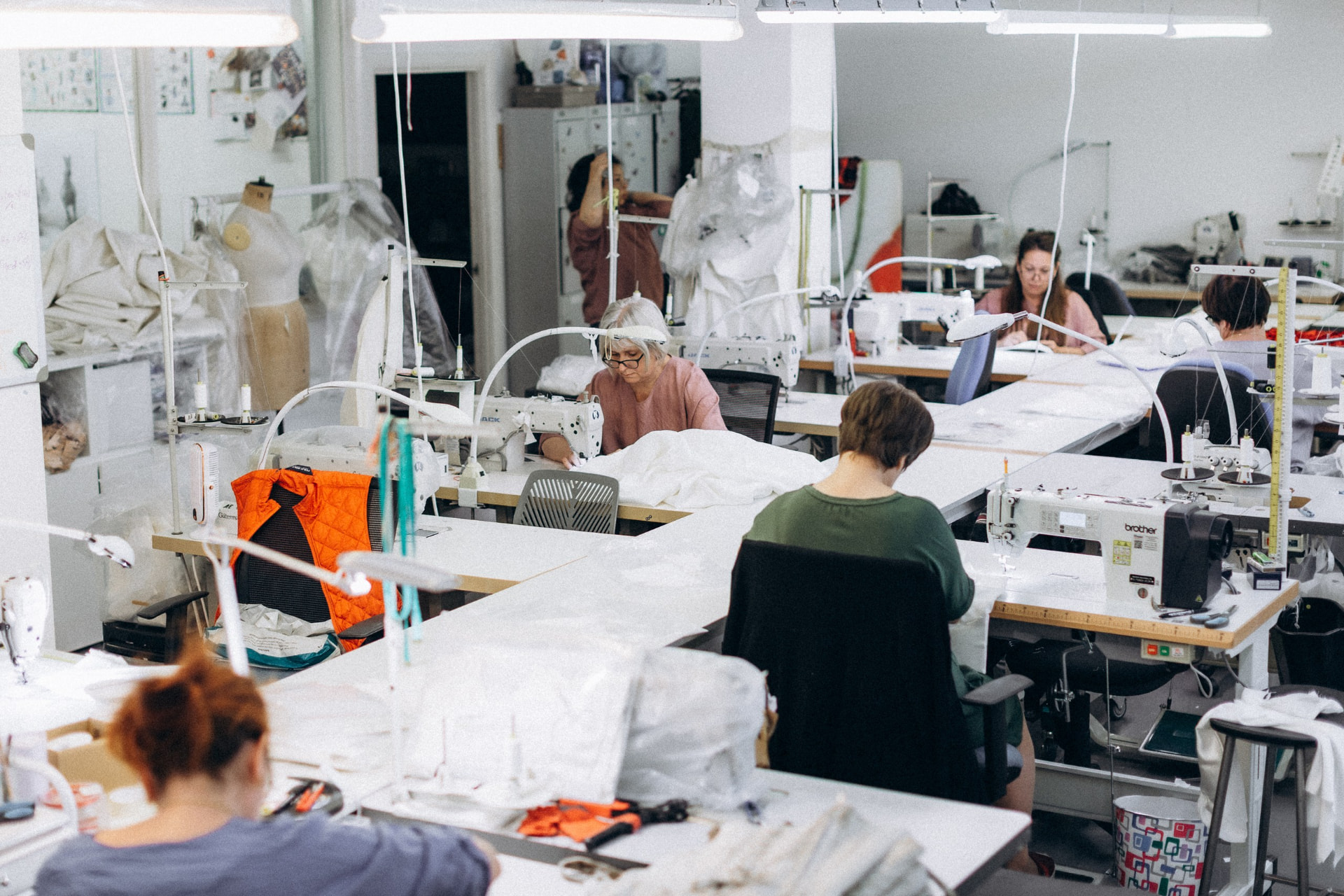 Inside the CMT Studio workroom, the team cutting and sewing garments in production
